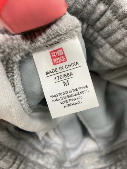 Embroidered grey fleece-lined pants with lettering